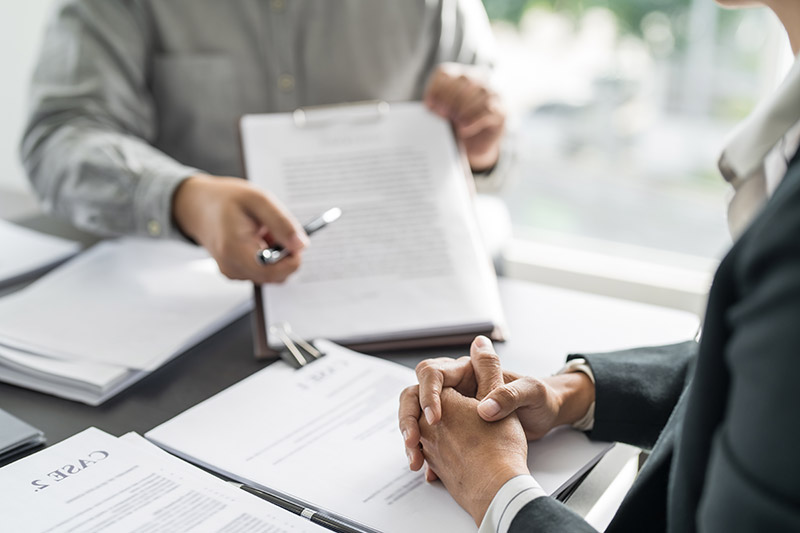 person pointing at legal documents