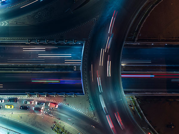 road at night with blurred traffic, seen from above