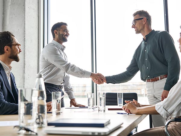 two men shaking hands in meeting