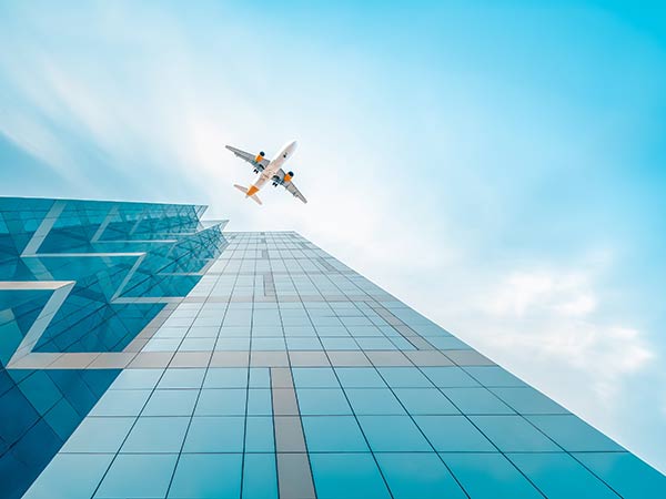 Plane flying over skyscrapers