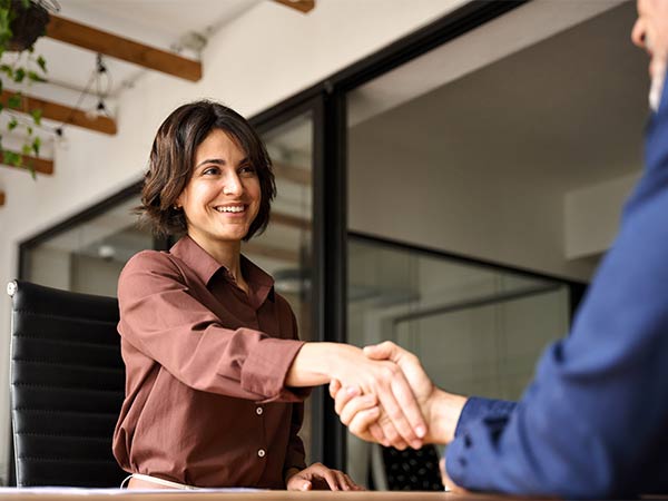 woman shaking hands in meeting
